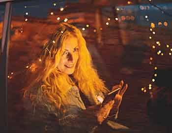 Woman in car looking at Christmas Lights